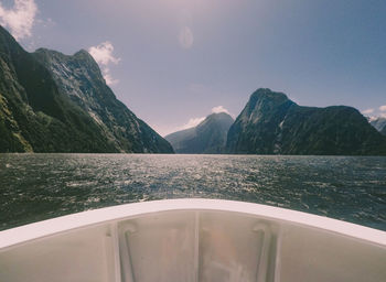 Scenic view of sea and mountains against sky