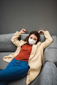Portrait of woman sitting on sofa