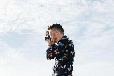 Low angle view of man standing against sky