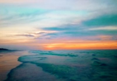 Scenic view of dramatic sky over sea during sunset