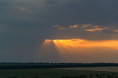 Scenic view of field against sky during sunset