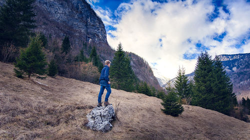 Full length of woman standing on mountain against clear sky