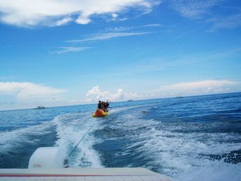 Man on boat in sea against sky