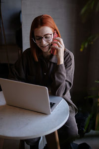 Smiling businesswoman looking at laptop