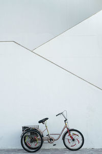 Bicycles parked on snow covered wall