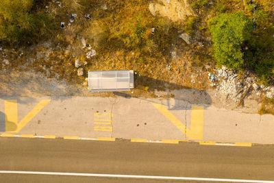 High angle view of yellow crossing sign on road