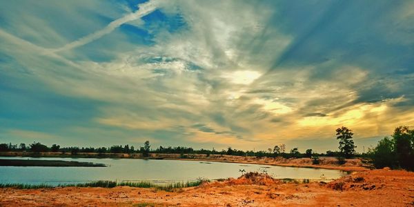 Scenic view of lake against sky during sunset