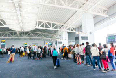 Rear view of people walking in subway station