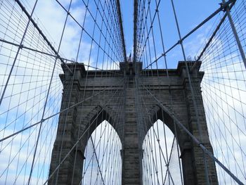 Low angle view of brooklyn bridge against blue sky