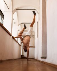 Full length of man dancing on floor at home