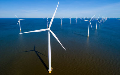 Low angle view of windmill against sky