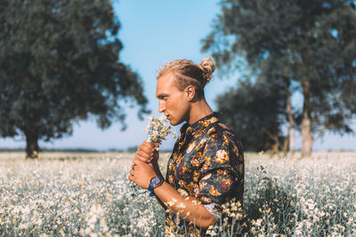 Young woman looking away on field