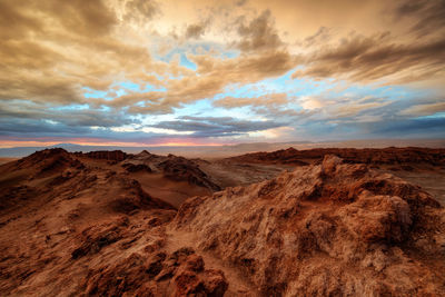 Scenic view of desert against sky during sunset