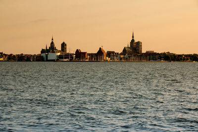 Scenic view of river by buildings in city