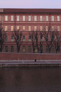 Building by river against sky