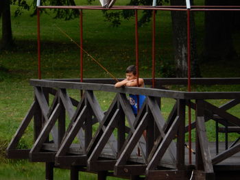 Woman sitting on railing