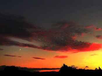 Scenic view of silhouette trees against sky at sunset