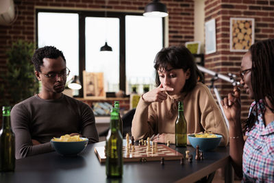 Thoughtful businesswoman playing chess