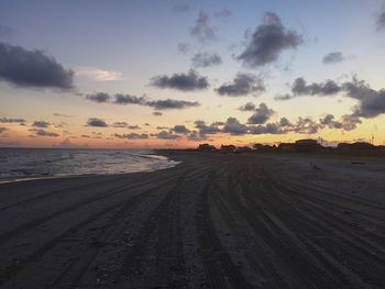 Scenic view of beach against sky during sunset