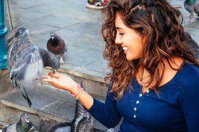 Young woman eating birds