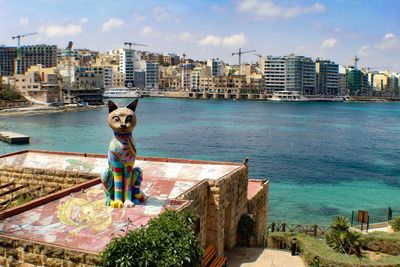 View of sea and buildings in city