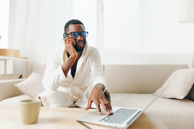 Young woman using laptop at home