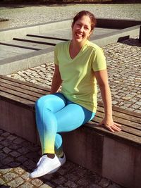 Portrait of a smiling young woman sitting on seat