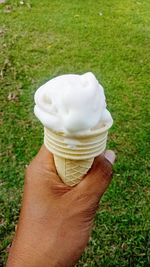 Close-up of hand holding ice cream cone