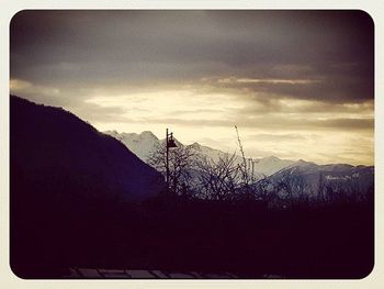 Scenic view of mountains against cloudy sky