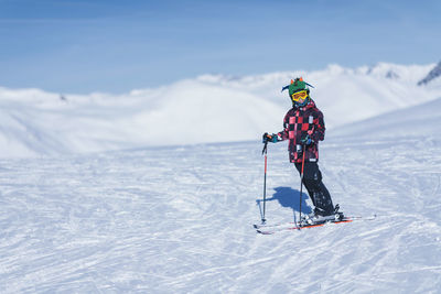 Portrait of boy skiing on snowcapped mountain