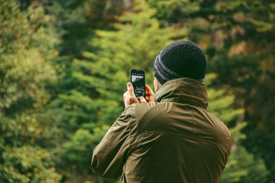 Rear view of person photographing