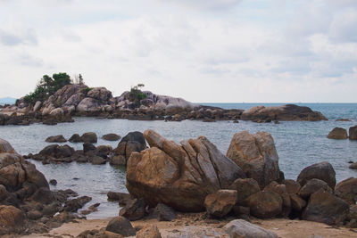 Rocks on beach against sky