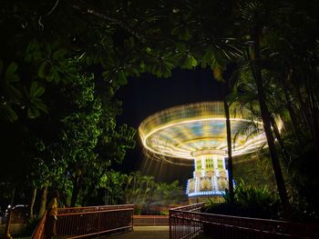 Blurred motion of illuminated trees by plants at night