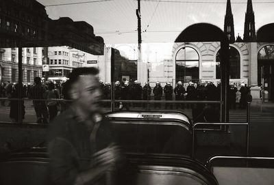 People walking on train in city