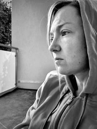 Close-up portrait of teenage girl looking away at home