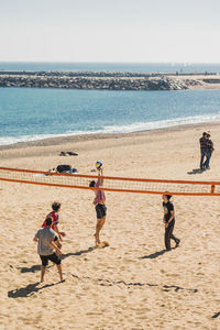 People on beach against sky