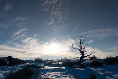 Scenic view of snow covered landscape against sky during sunset