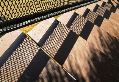 Shadow of railing on footpath