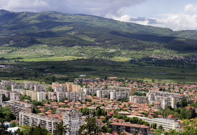 High angle view of buildings in city and mountain