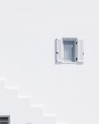 Close-up of electric lamp against white wall