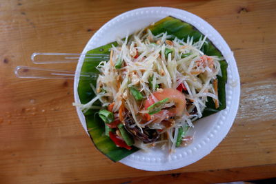 High angle view of chopped fruits in bowl on table