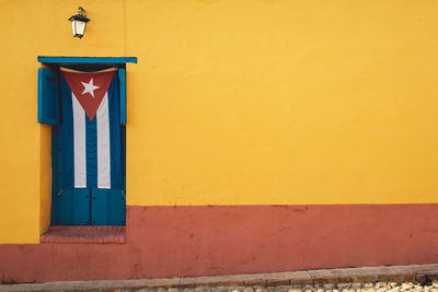 Closed door of building with a flag