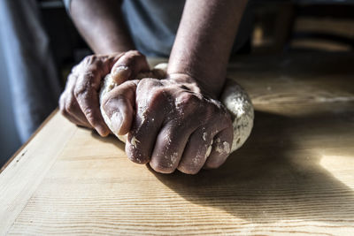 Close-up of person hand on table