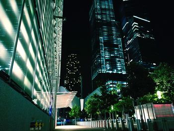 Low angle view of illuminated skyscraper against sky at night