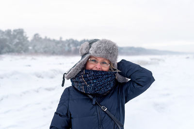 Smiling woman on the background of winter landscape, jurmala, latvia. 