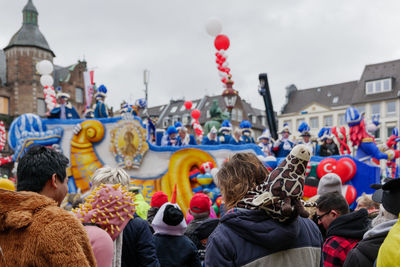 Crowd of people at parade with fancy costume in carnival on rose monday in düsseldorf, germany.