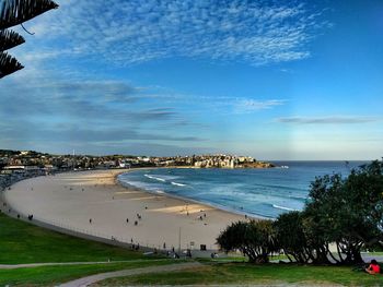 Scenic view of beach against cloudy sky