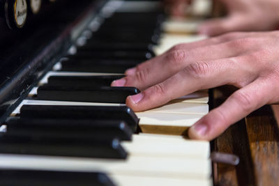 Close-up of hands playing piano