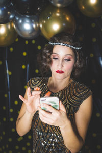 Portrait of a beautiful young woman drinking glass