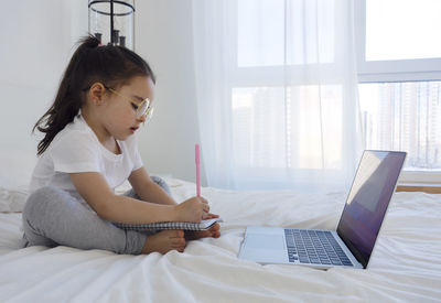 Young woman using laptop at home